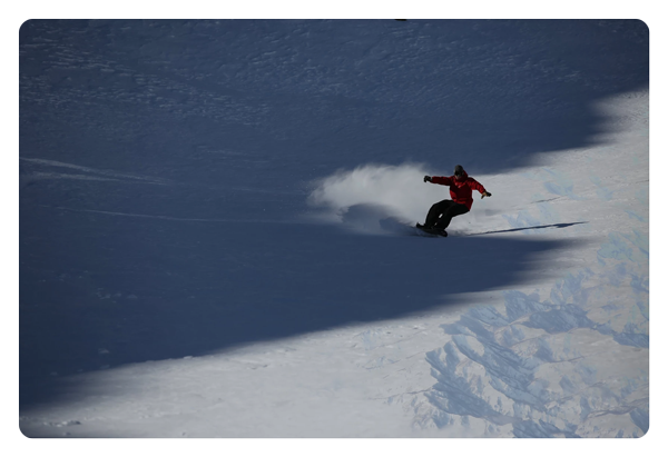 aerial image of someone snowboarding taken with the canon lens
