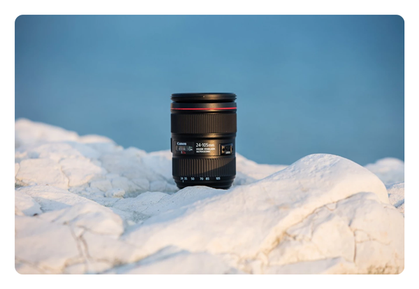 canon lens stood of a white rock surface
