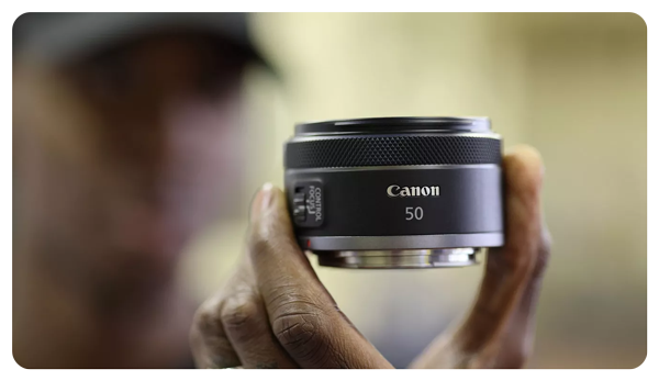 someone holding the canon rf 50mm