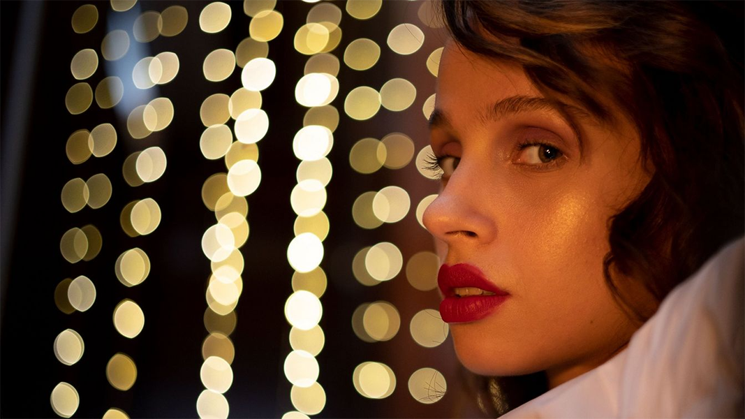 sample image of a woman in front of lights taken with the canon rf 50mm