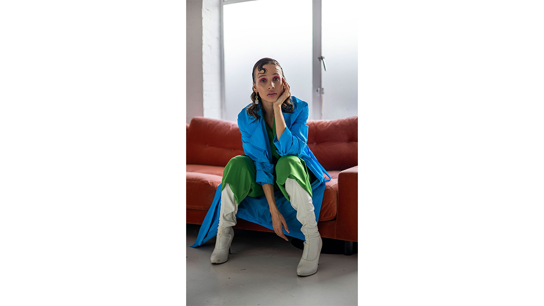 sample image of a woman sat on a sofa taken with the canon rf 50mm