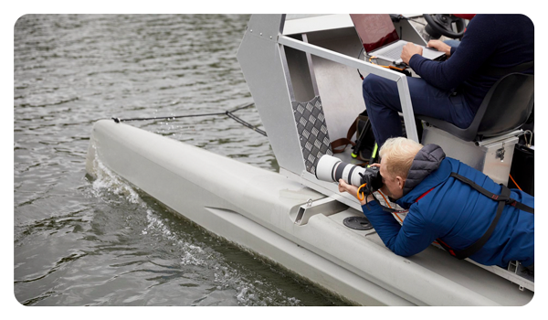 sometaking a photo using the canon 70 200 lens on the edge of a boat