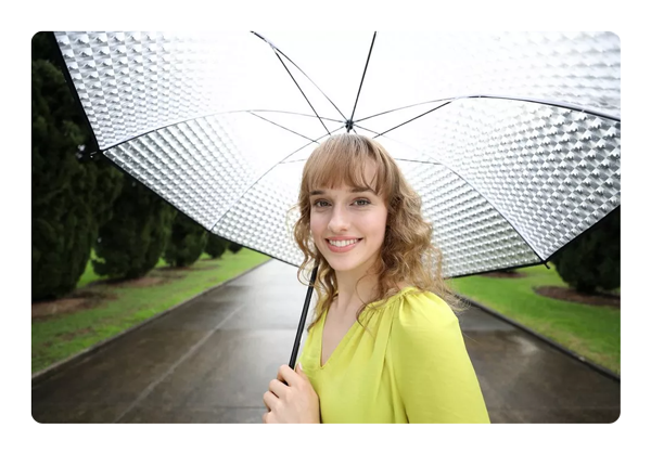 portrait of a woman holding an umbrella taken with the canon 35mm lens