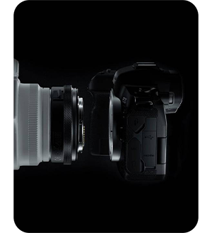 side view of the canon r camera on a black background