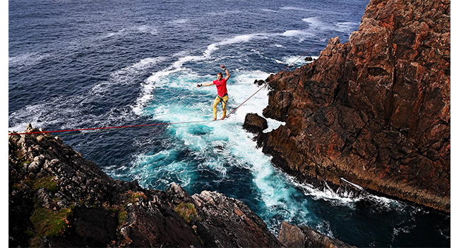 sample image of someone tightrope walking between 2 cliffs taken on the canon r