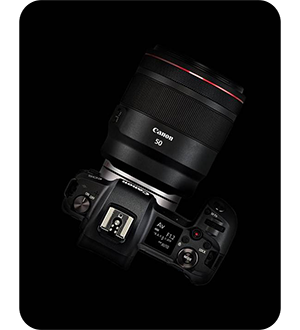 top view of the canon r camera on a black background
