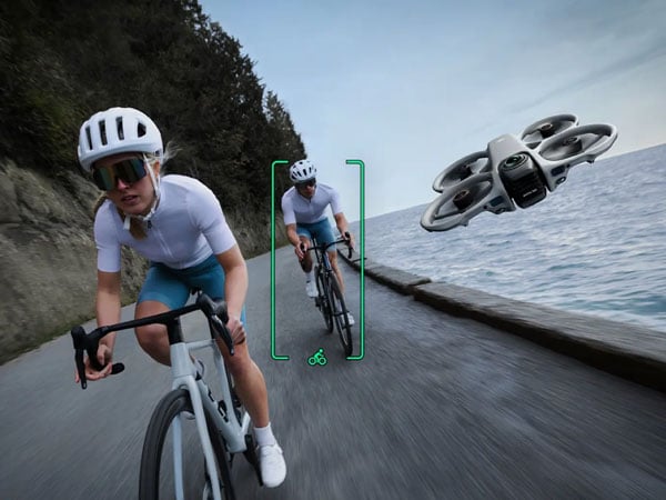 dji avata 360 tracking a cyclist while flying next to them