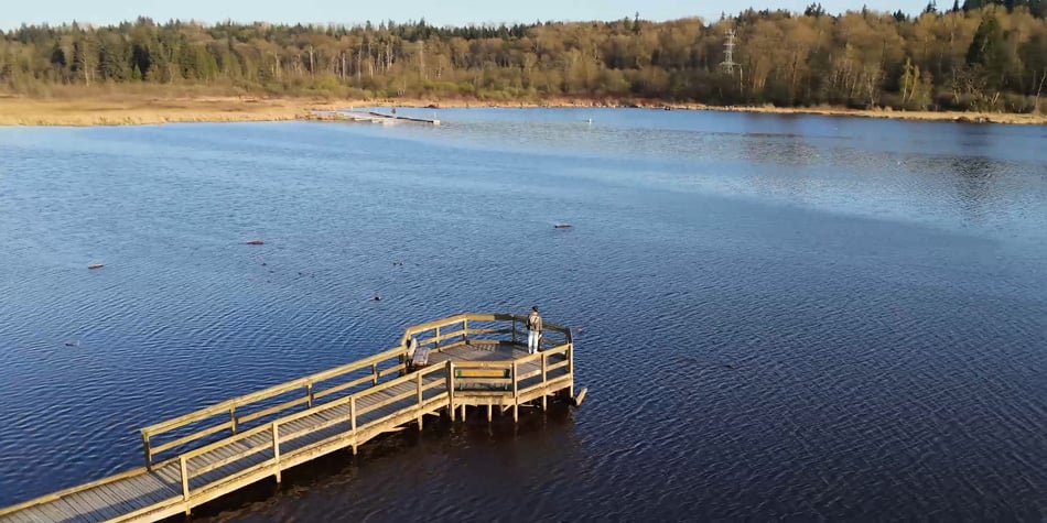 aerial show of a man overlooking a lake