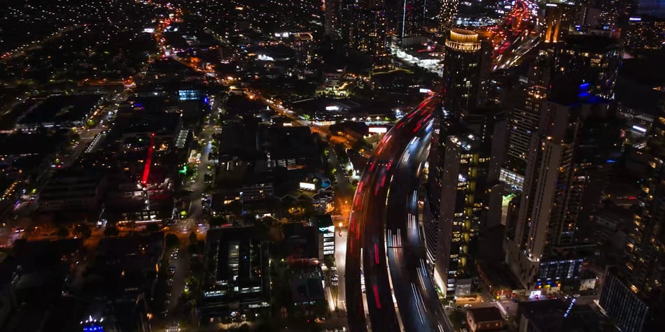 high-angle aerial view of a bustling city at night