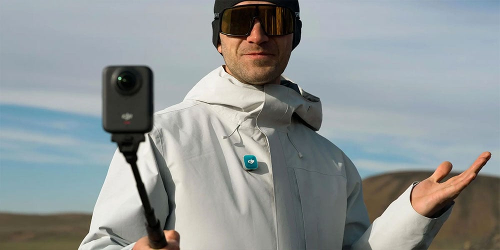 a man in goggles using the dji osmo 360 and mic mini 2