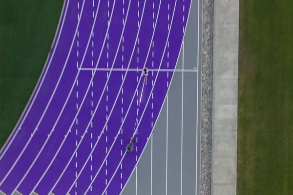top dow view of someone being filmed running on a track