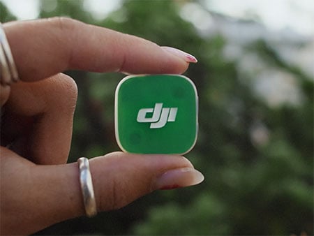 close up of someone holding the dji mic mini 2