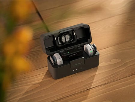 dji mic mini 2 in a case on a wooden table
