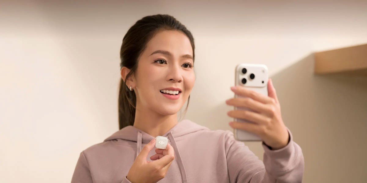 a woman holding the mic mini 2s and a smartphone