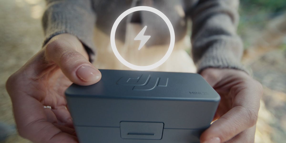 someone holding the dji mic mini 2s in the charging case
