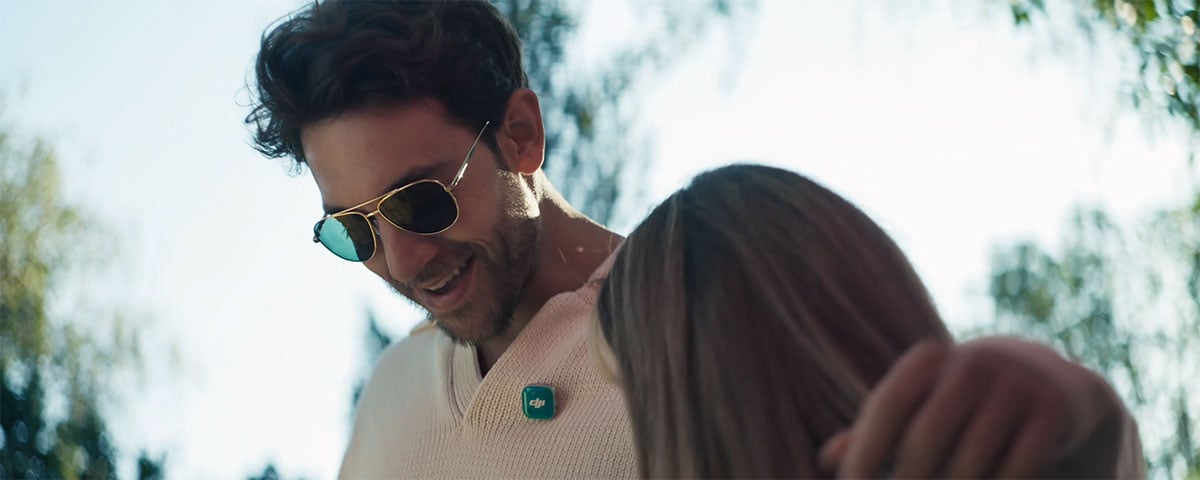 a man talking to a woman while wearing the dji mic mini 2s