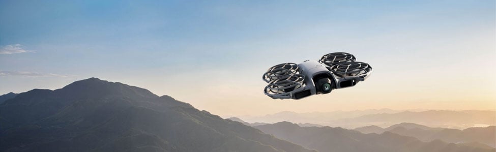 dji neo 2 drone flying over mountains