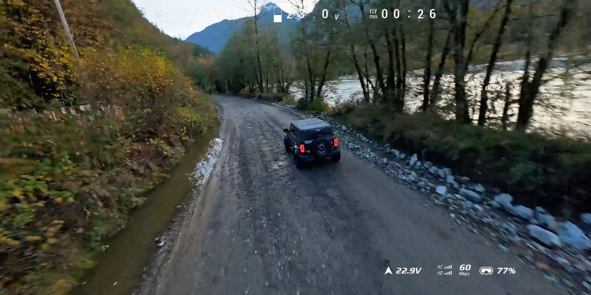 sample image from footage of a truck driving down a dirt path next to a river