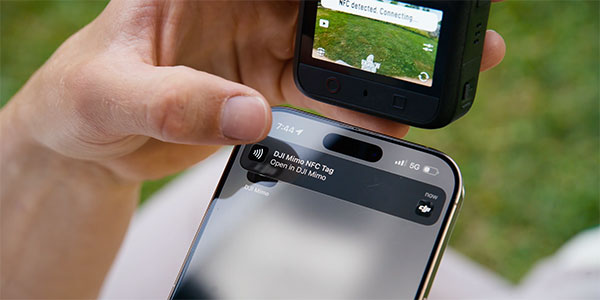 Person syncing a DJI Osmo 360 II action camera to an iPhone using NFC Quick Connect