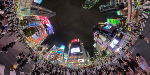 360-degree little planet fisheye view of the bustling neon-lit Shibuya Crossing