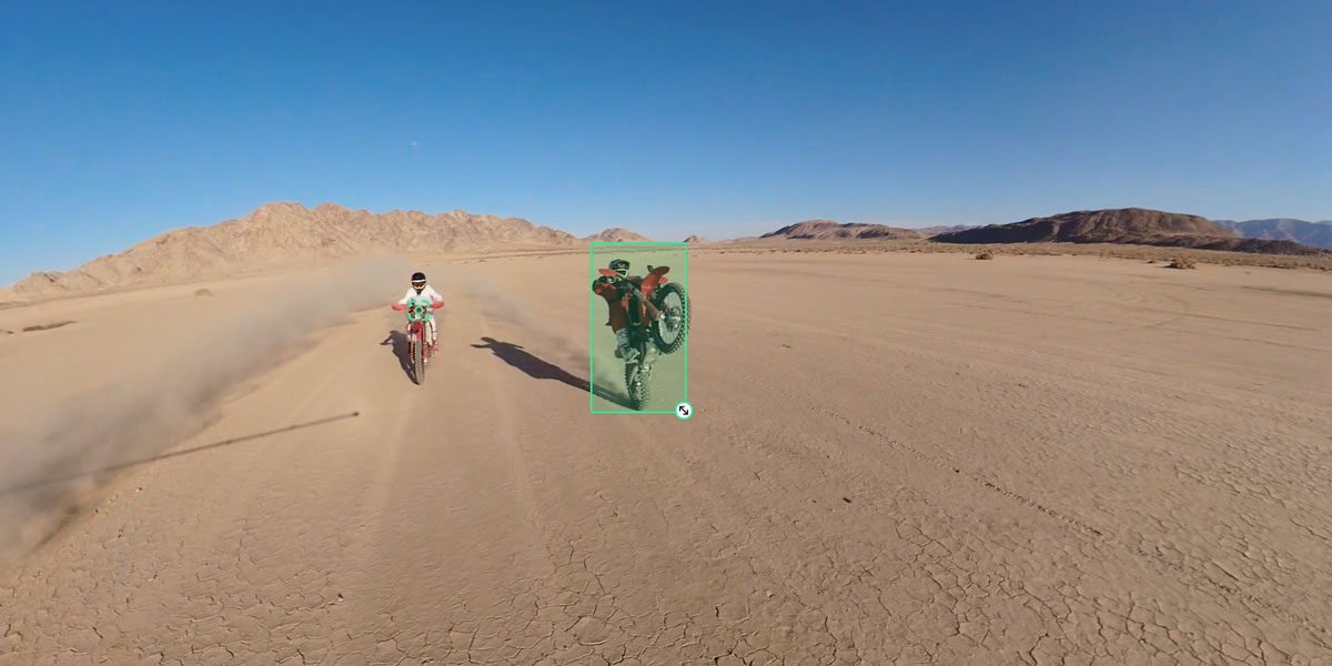 person doing a wheelie on a motorcycle in the desert