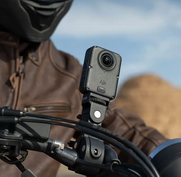 DJI Osmo 360 II action camera mounted on a motorcycle handlebar with heavy-duty clamp mount