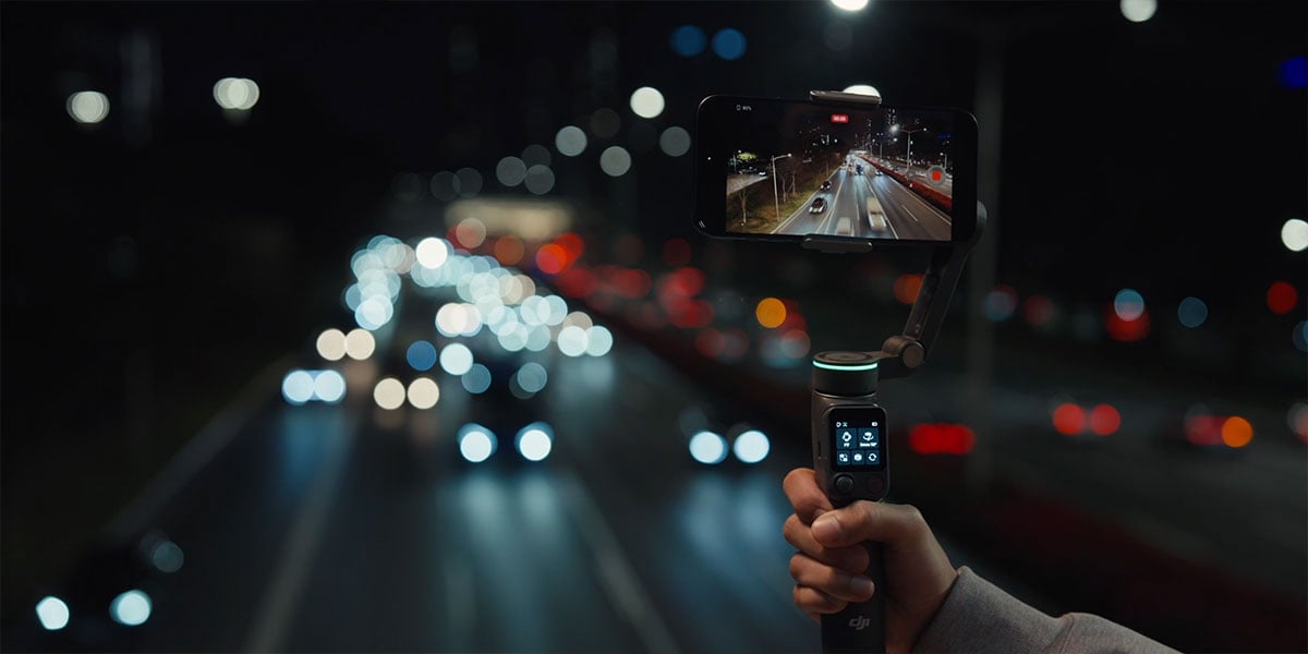 someone recording a slow shutter timelapse of a highway with the dji osmo mobile 8p