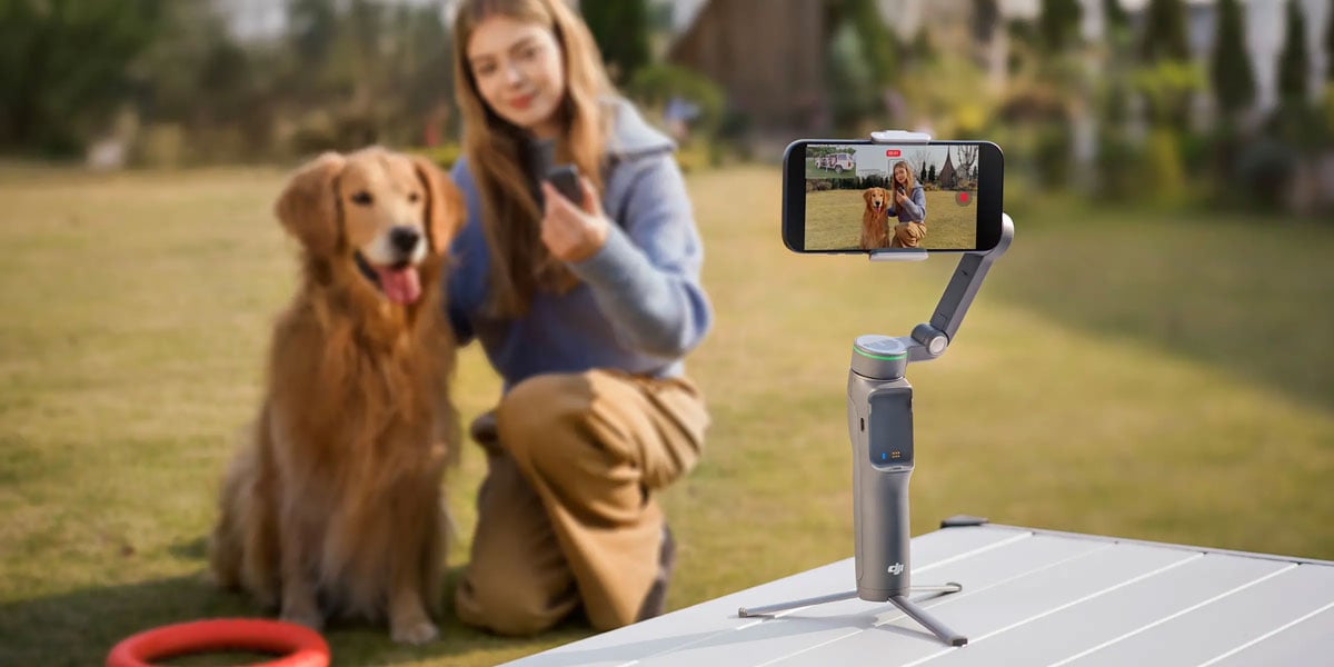 a woman taking a photo with her dog using the dji osmo mobile 8p
