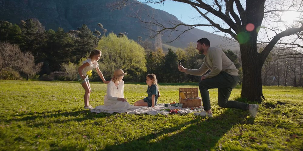 a family picnic with the dad filming using the dji osmo pocket 4