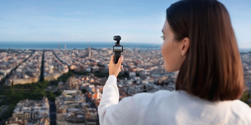 someone filming a city skyline using the dji osmo pocket 4