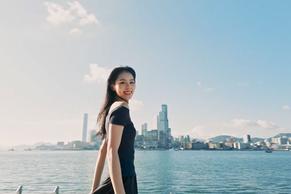 portrait of a woman with shanghai in the background with a film tone filter applied