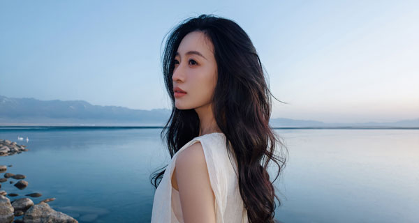 portrait of a woman overlooking the ocean with cool tones