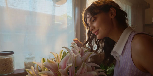 portrait of a woman watering flowers