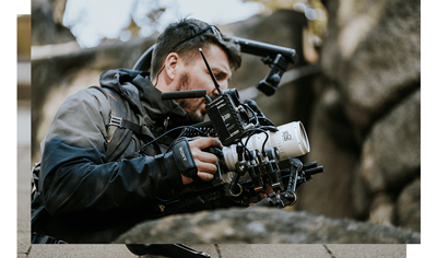 Camera operator with a complete steady cam rig with DZOFILM CATTA Zoom lens attached to his sony mirrorless camera