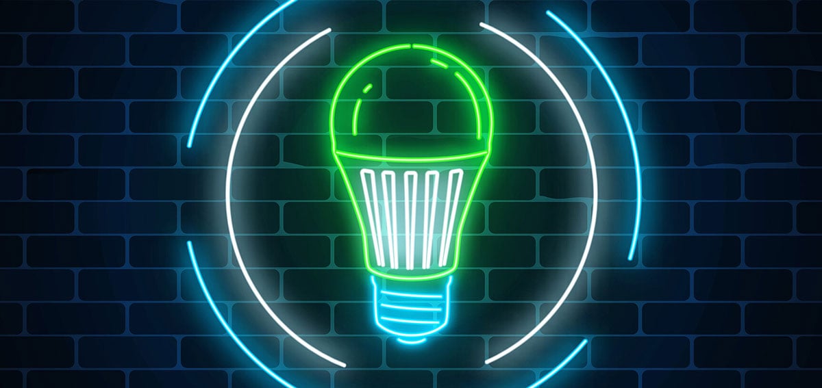 neon light bulb sign on a brick wall