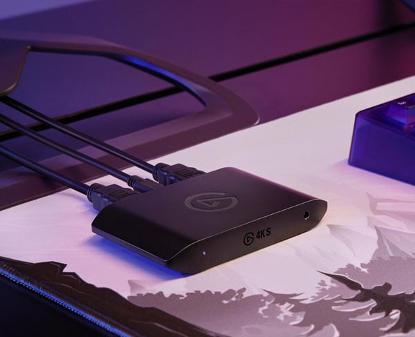 Elgato Game Capture 4K s external capture card resting on a desk mat