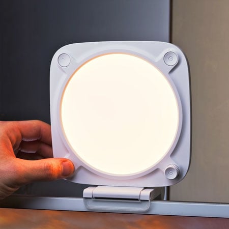 someone adjusting the Elgato key light neo