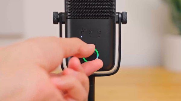 someone adjusting the dial on the wave:3 mic