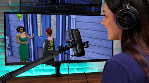a streamer playing the sims while talking into an elgato mic