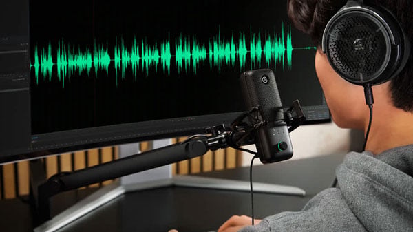 someone talking into a mic while monitoring their audio