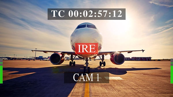 a commercial passenger aircraft parked on an airport tarmac with an overlay displaying timecode and camera information