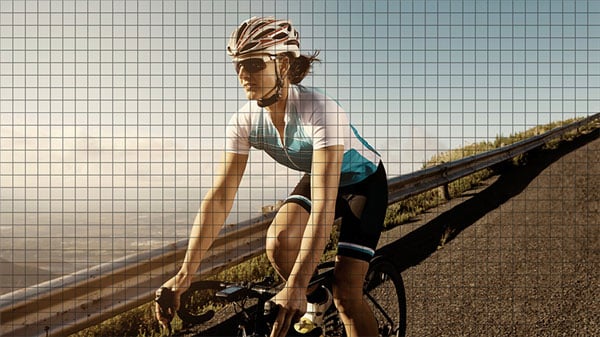 image of a cyclist riding a road bike on an open road with a custom grid over the top