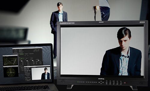 Flanders Scientific production and reference broadcast monitor paired with a laptop running video scopes and control software