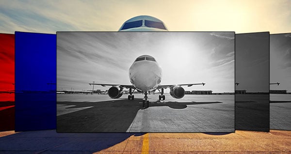 Front view of an airplane on a runway displayed across multiple color-tinted panels