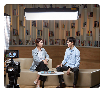 godox light suspended above two people talking