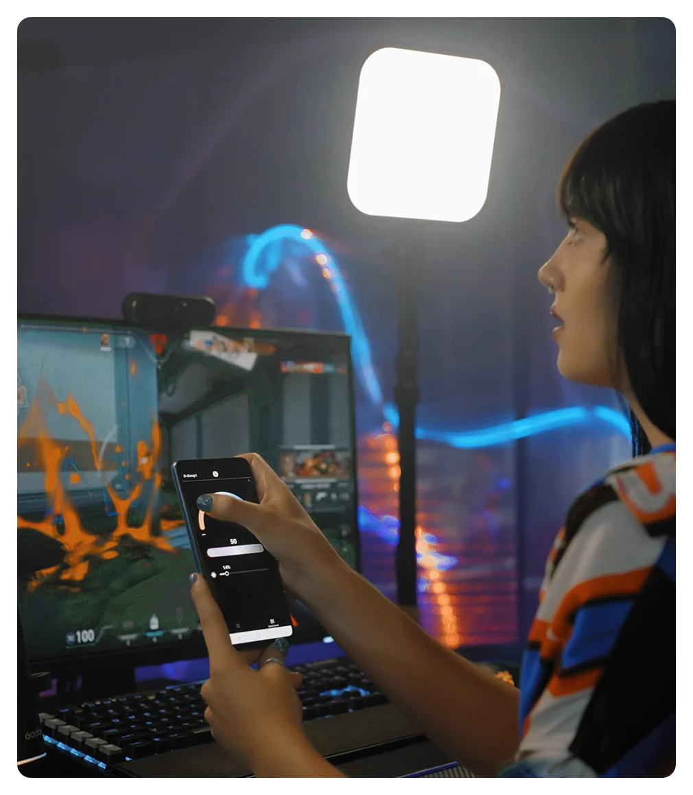 woman controlling the godox es30 lights using the godox light app on her phone