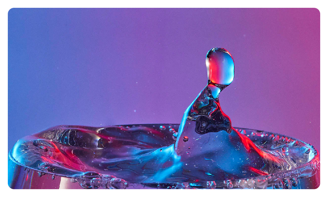 godox panel lights with blue and pink ligh singing on water splashing in the air from a glass