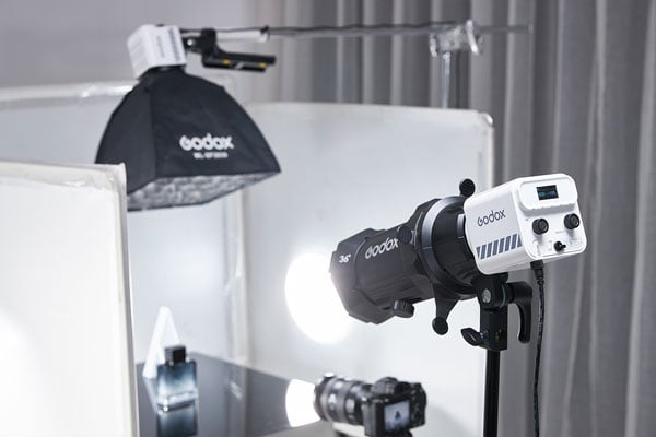 godox ml60iibi being used ina photo studio while taking photos of an purfume bottle