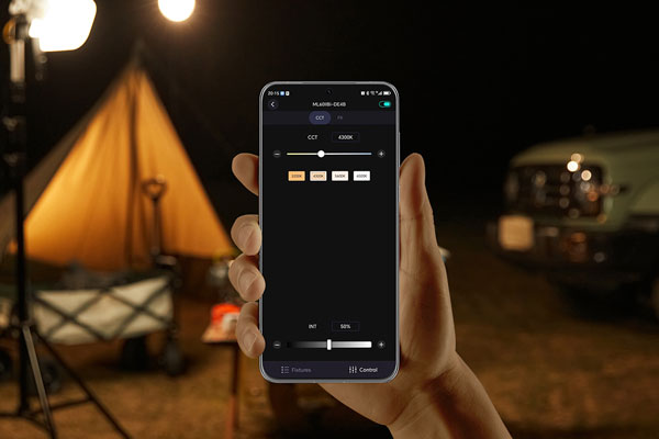 someone holding a smartphone showing the godox light app interface