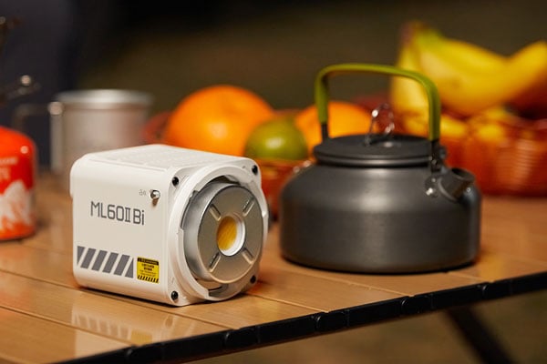 godox ml60iibi on a wooden table next to a kettle